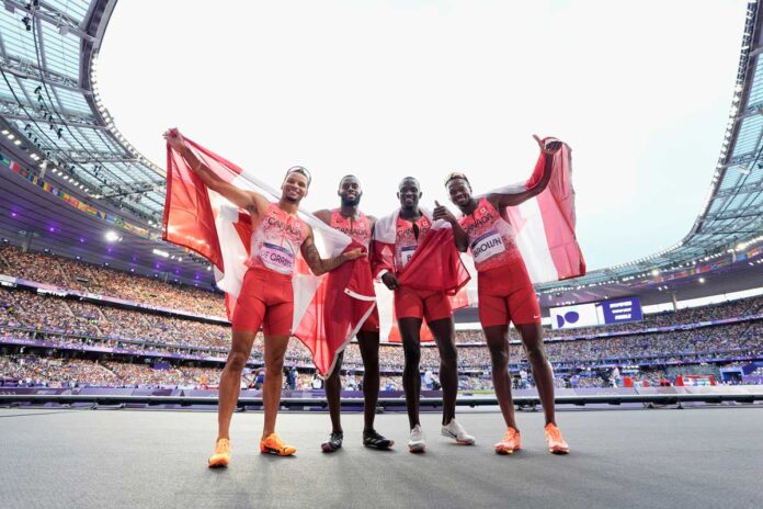 Team Canada’s men's 4x100 relay team Andre De Grasse, Brendon Rodney, Jerome Blake, and Aaron Brown pose after winning the gold medal at the 2024 Paris Olympic Games in France on Friday, August 9, 2024. Photo by Mark Blinch/© 2024 Canadian Olympic Committee